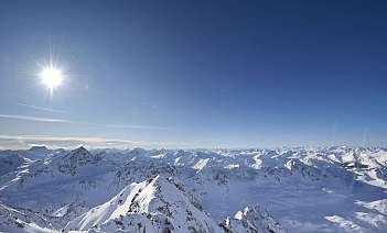 Schneebedeckte Berglandschaft Weite Aussicht auf schneebedeckte Berge unter klarem Himmel.