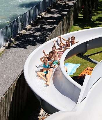 Children on a water slide Group of children enjoying a water slide on a sunny day.